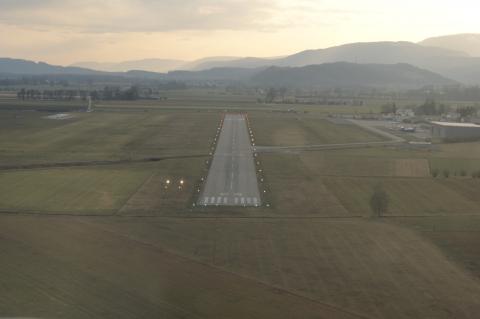 Short final of Runway 25. 1000m long, 23m wide, concrete runway.