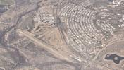 An aerial view of Kearny Airport (E67) and the nearby town of Kearny.